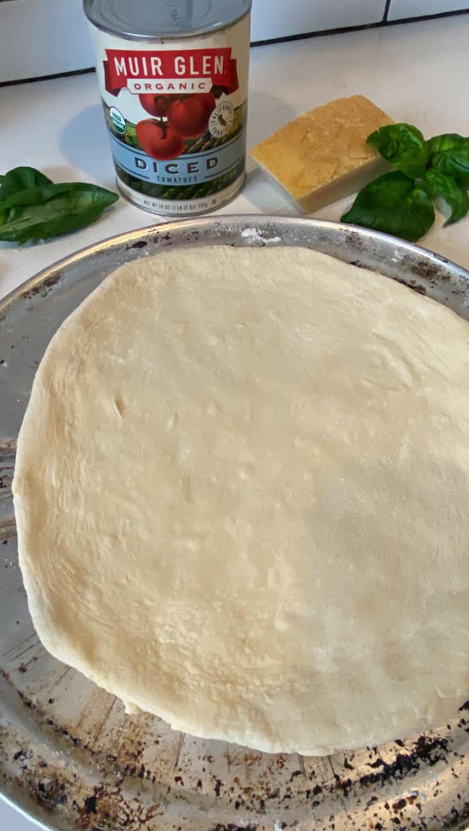 Stretch out the pizza dough to a 10 inch circle.