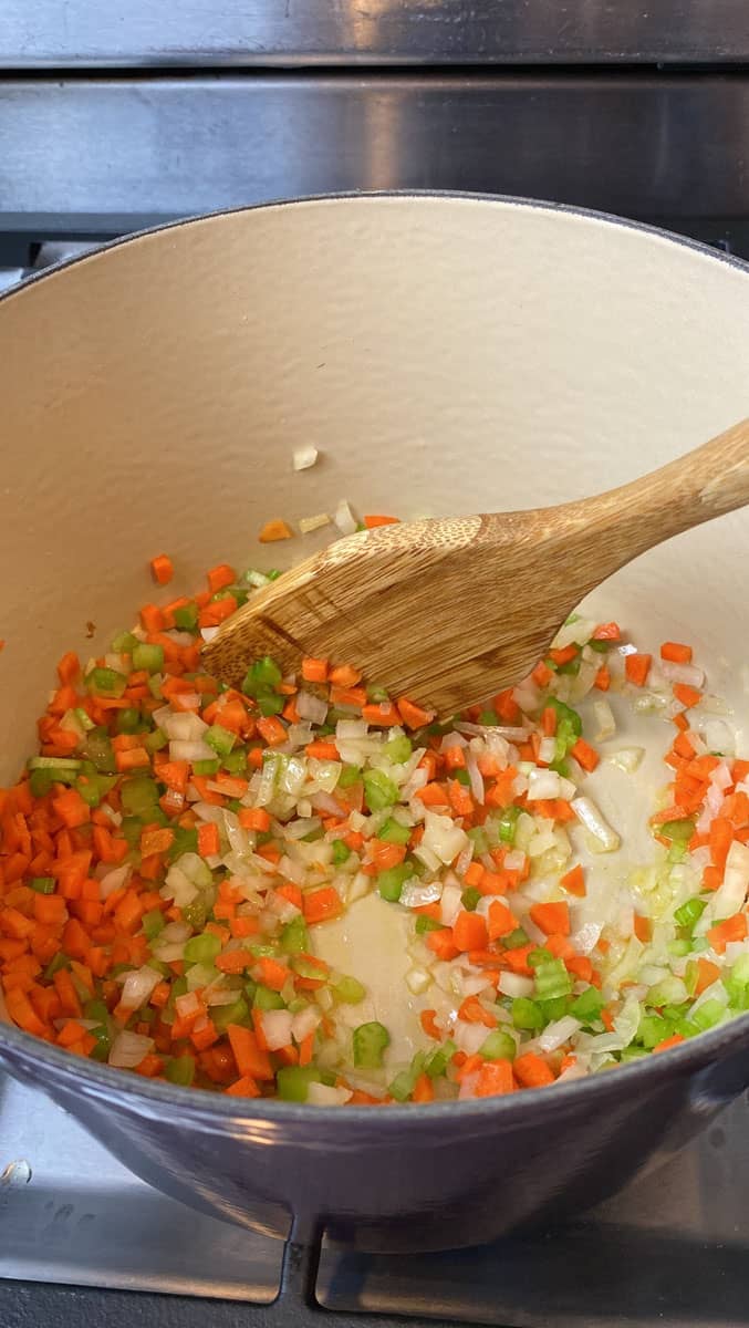 Stir the chopped carrots. celery and onion together in a dutch oven.