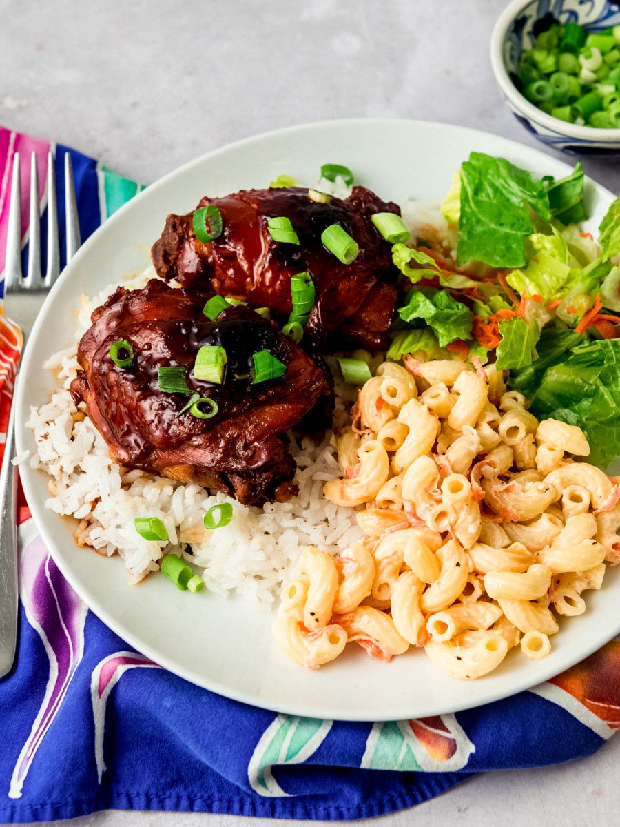 Easy Hawaiian style shoyu chicken served on top of rice with macaroni salad and green salad.