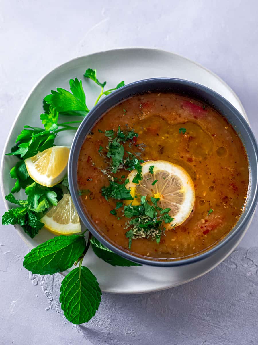 Turkish lentil soup garnished with fresh mint and lemon.
