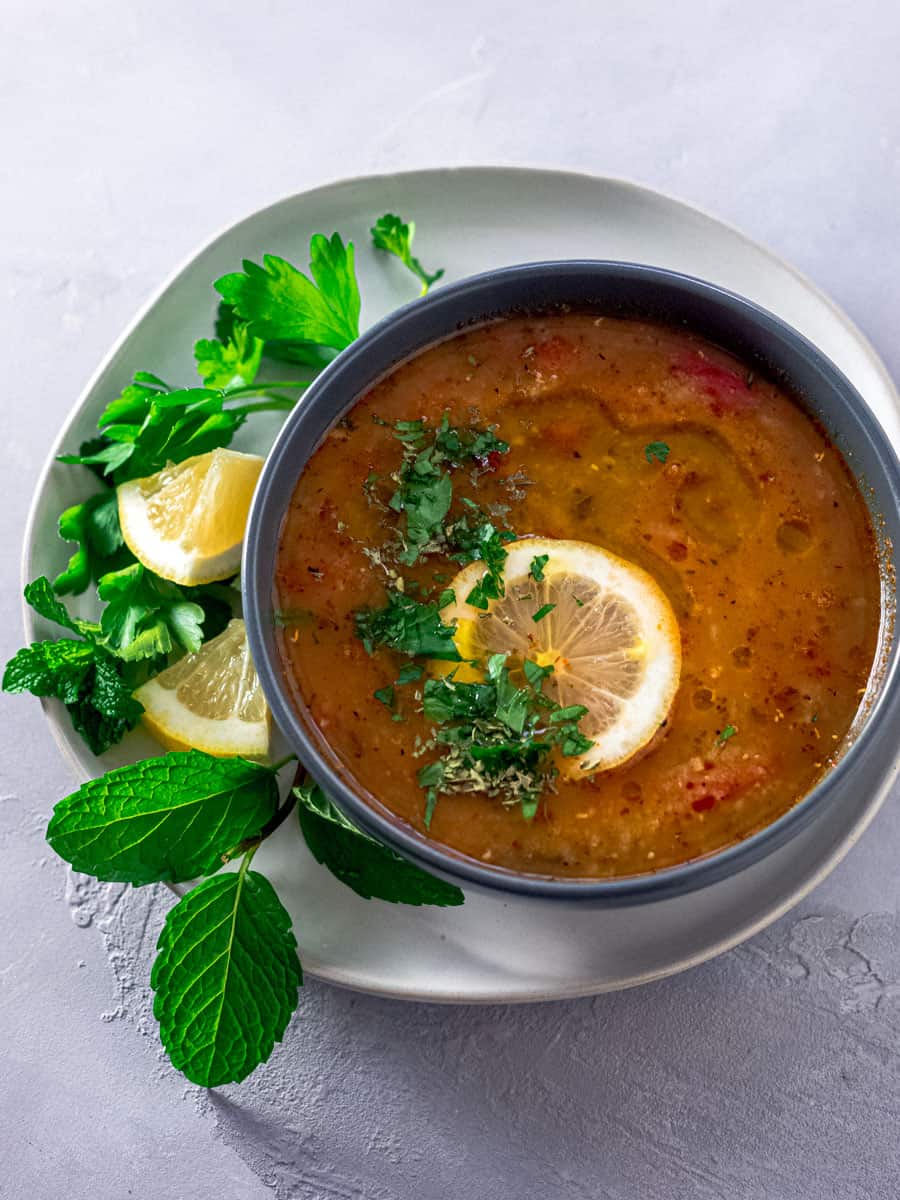 Turkish red lentil soup is made with red lentils, rice, quinoa and garnished with mint and lemon.