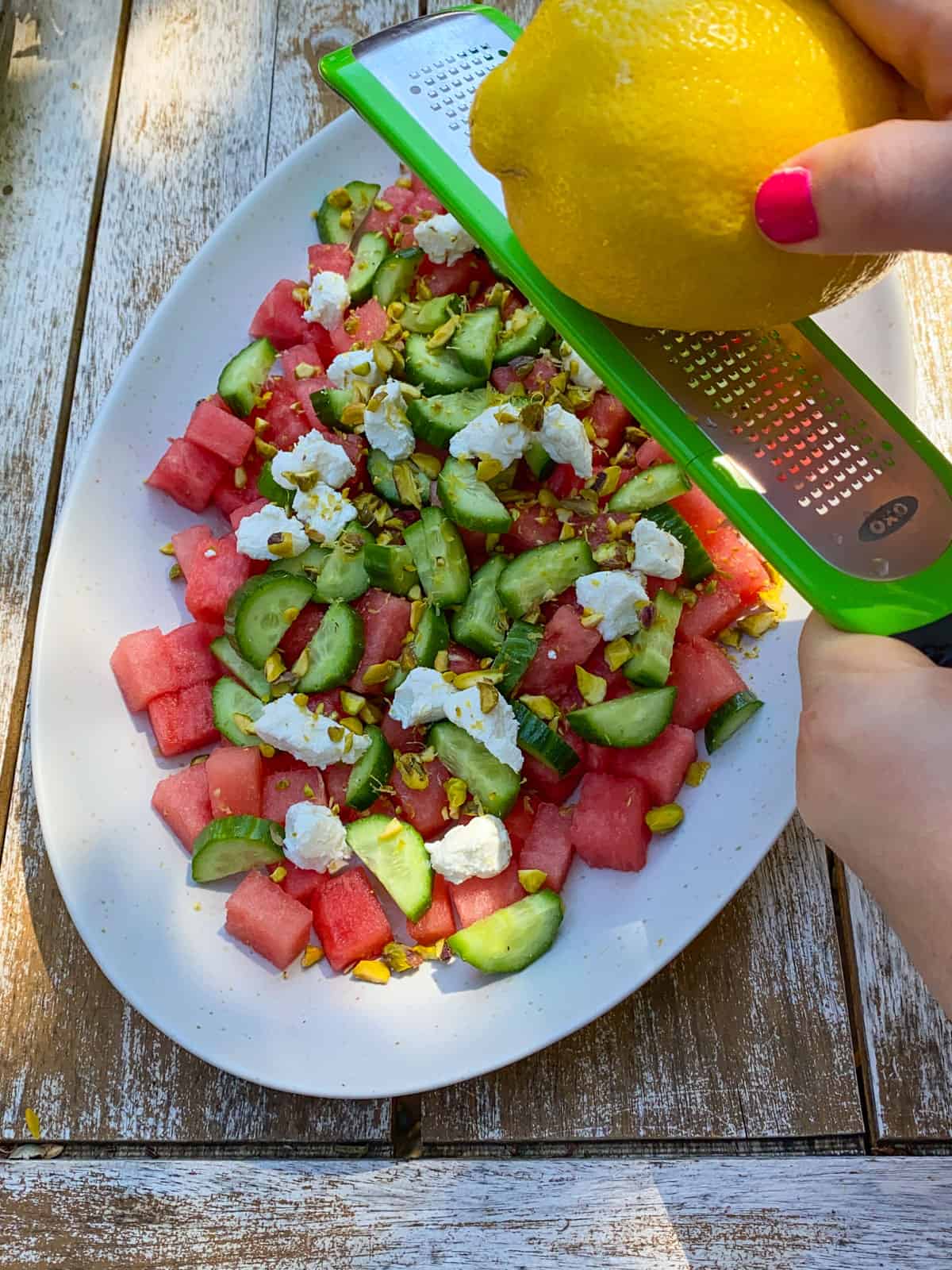 Add fresh lemon zest on top of the watermelon goat cheese salad.
