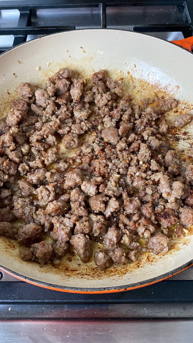 Break up the Italian sausage unto crumbled and cook until a nice crust forms on the sausage.