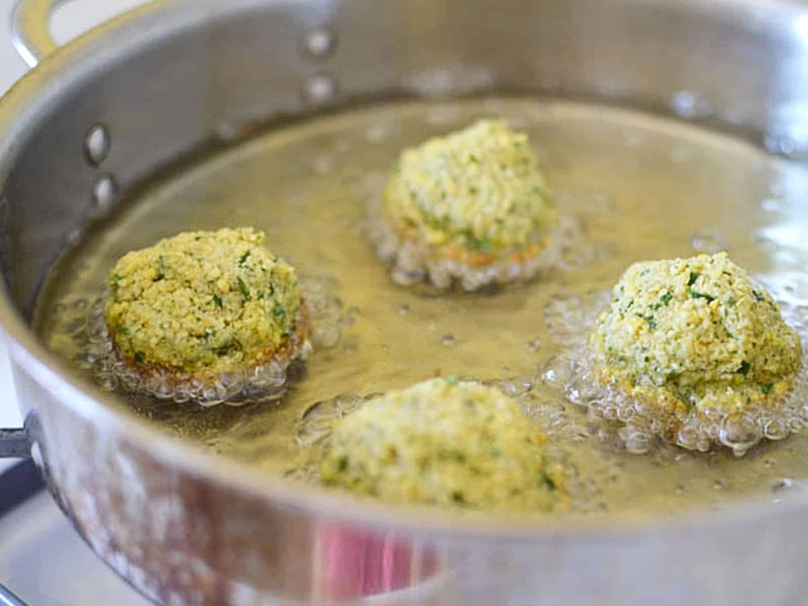 Form falafel into tablespoon sized balls and fry in hot oil until golden brown on first side. 