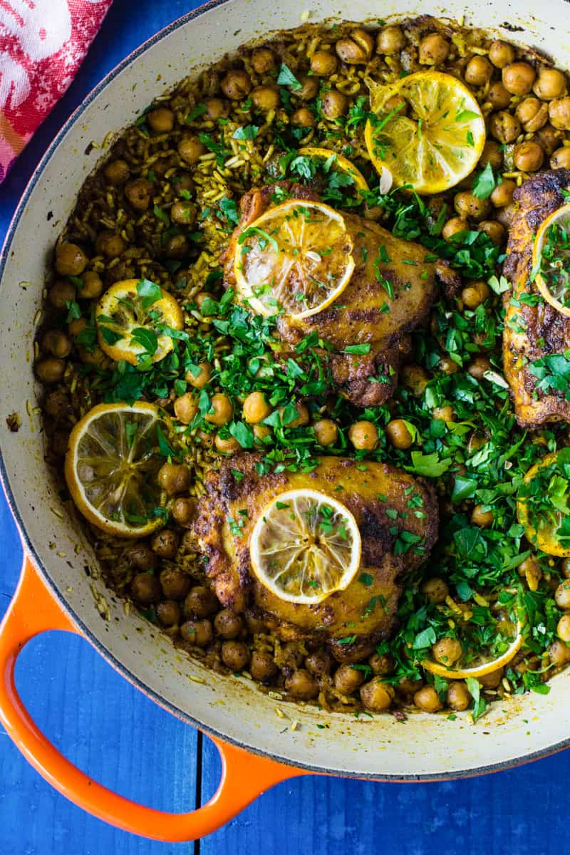One pot lemon chicken with rice and chickpeas is flavored with Mediterranean spices of sumac and cumin.