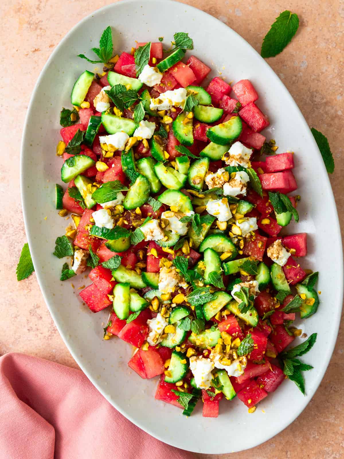 Watermelon cucumber salad layered with crumbled goat cheese, chopped pistachios and fresh mint.