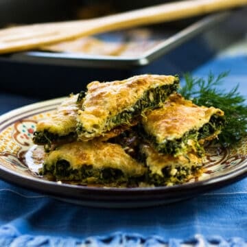 Turkish borek with spinach and feta filling that is cut into triangles.