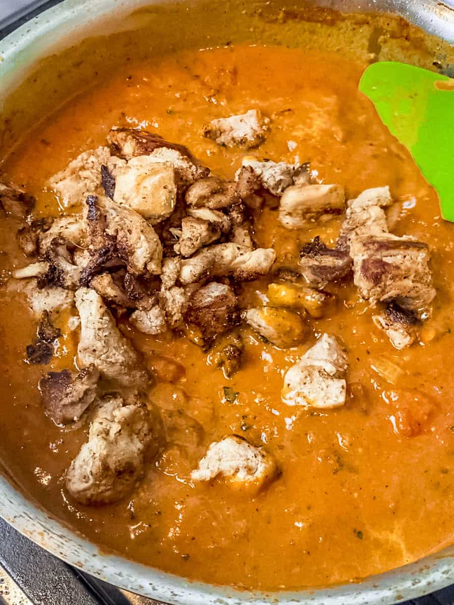 Add the cooked chicken to the creamy coconut masala sauce.