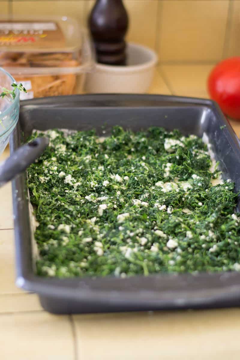Add the spinach and feta mixture onto the phyllo sheets and spread into an even layer.
