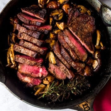Cast iron seared steaks with wild mushrooms and herbs.