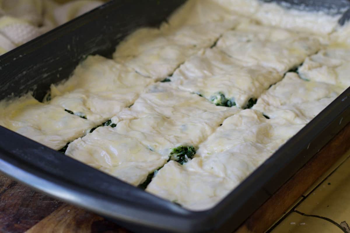 After the Turkish borek is layered, cut the borek into squares or triangles.