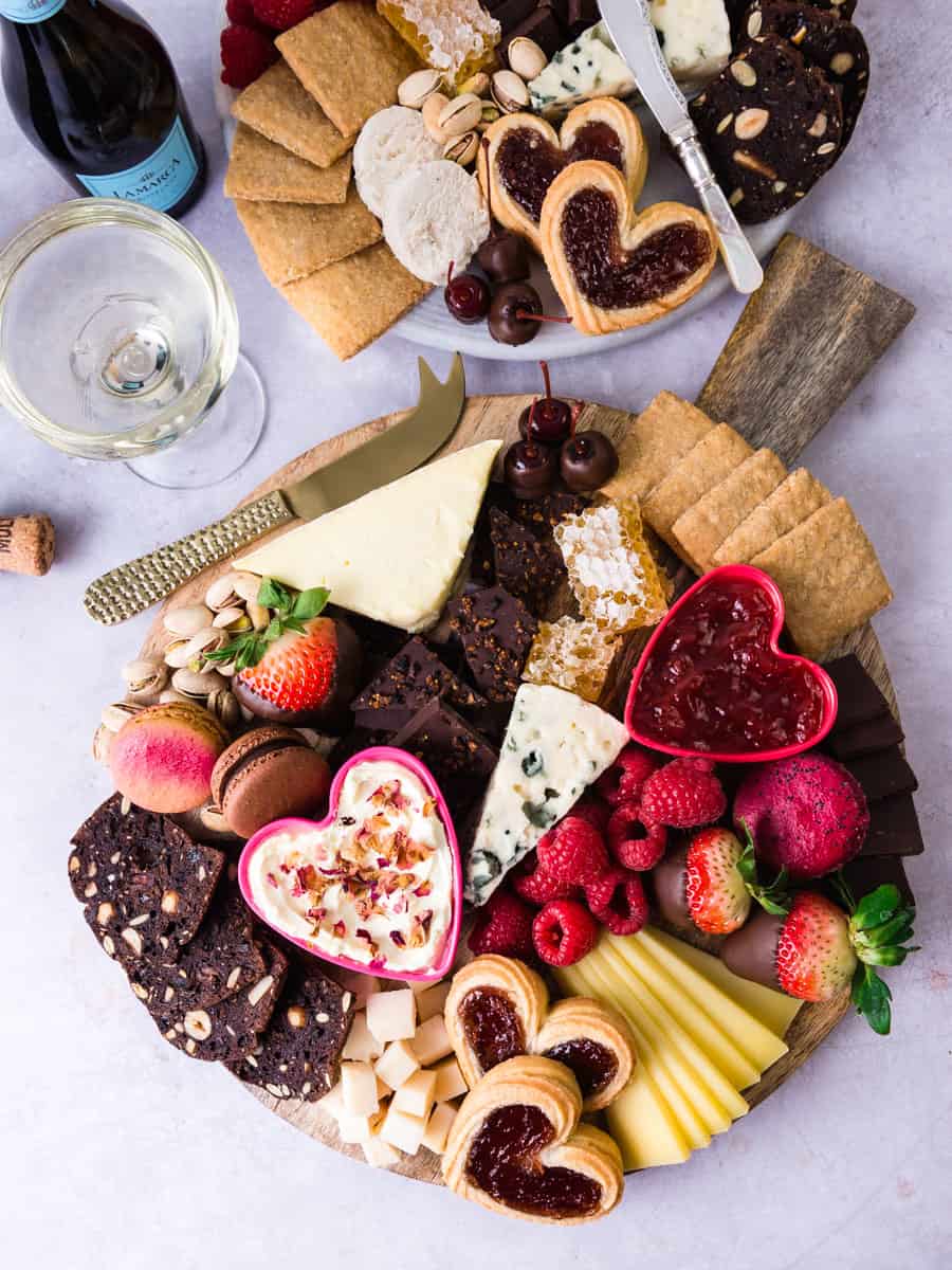 Dessert charcuterie board full of cookies, jams and cheese.