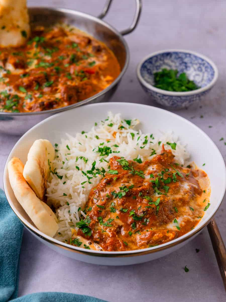 Serve easy chicken tikka masala with basmati rice in a bowl.
