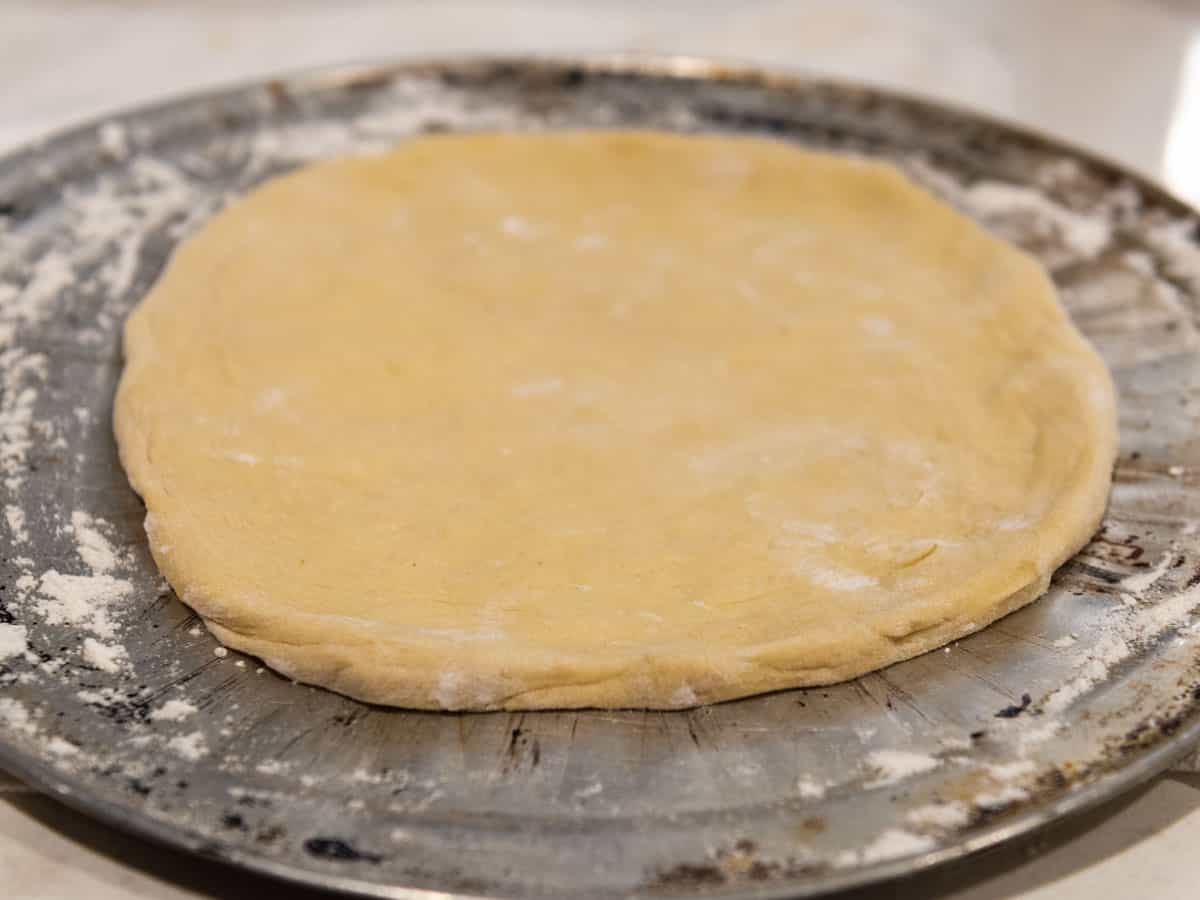 Roll out the pizza dough to a 10 inch circle.