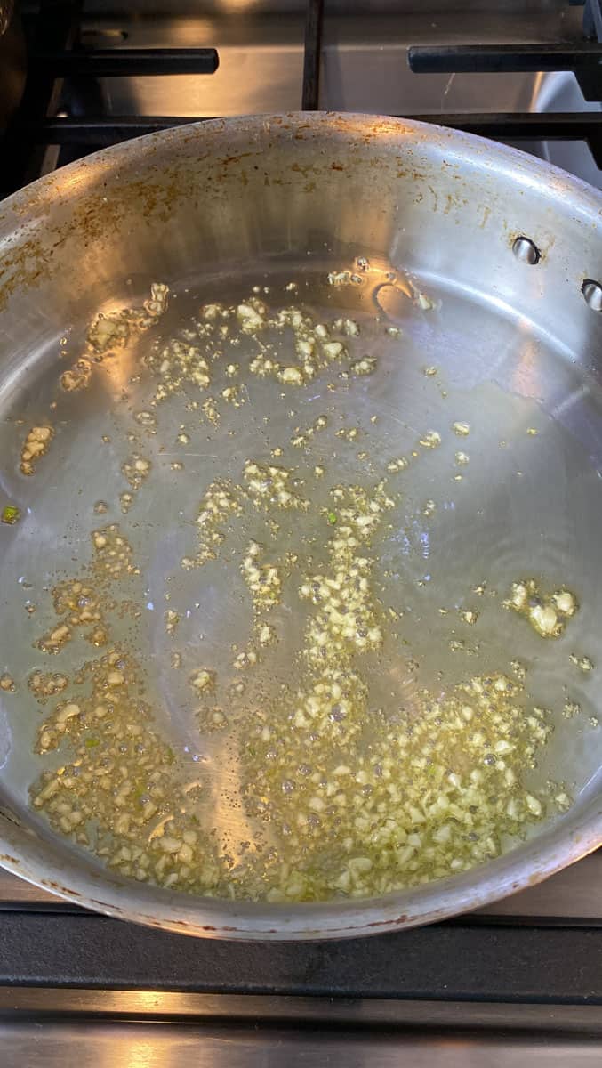 Sauté chopped garlic in olive oil until fragrant.