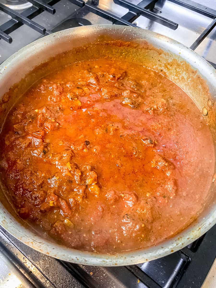 Simmer the chopped tomatoes and water in the masala spices so the flavors come together.