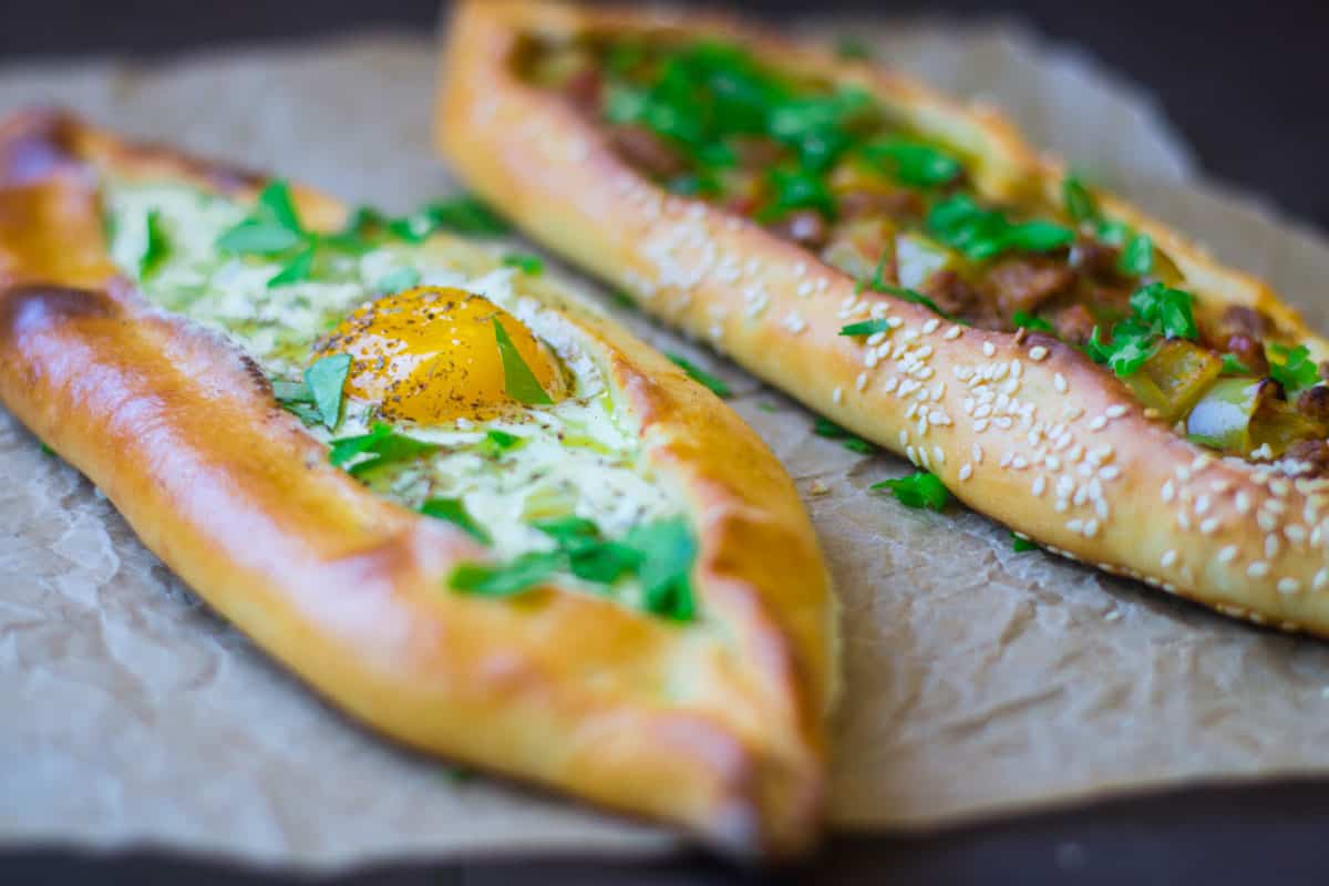 Turkish cheese pide with egg and another pide stuffed with ground beef.