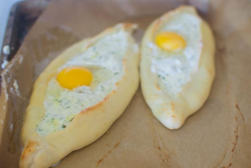 Cook the cheese pide for a few minutes then top the cheese with an egg and finish cooking until the egg is cooked through.