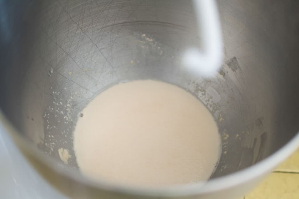 Add the yeast to warm water and allow to bloom before adding the dough ingredients.
