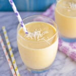 Creamy mango lassi with cardamom and topped with shredded coconut.