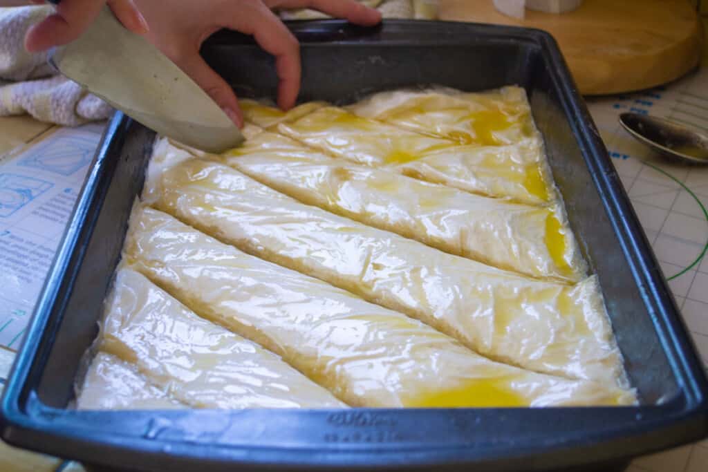 Before cooking the baklava, cut the baklava into squares or triangles.