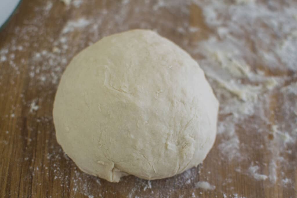 Roll the pide dough on a lightly floured surface into a smooth ball.
