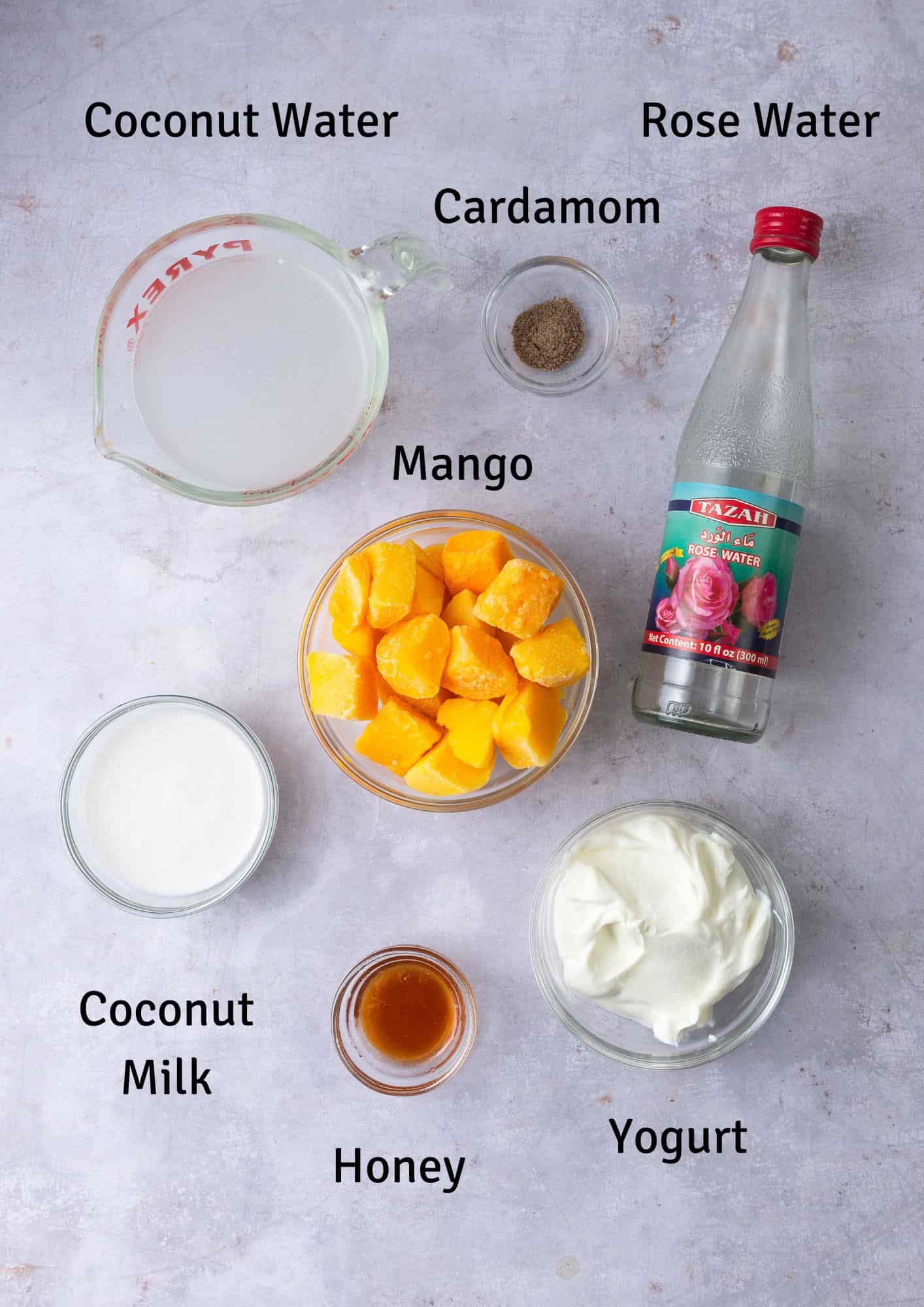Ingredients for mango lassi with rose water, cardamom and coconut milk.