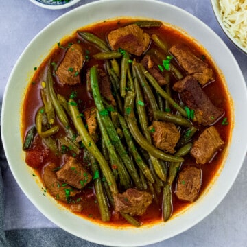 Fasulye is a hearty green bean and tomato stew with cubed meat and served with rice.