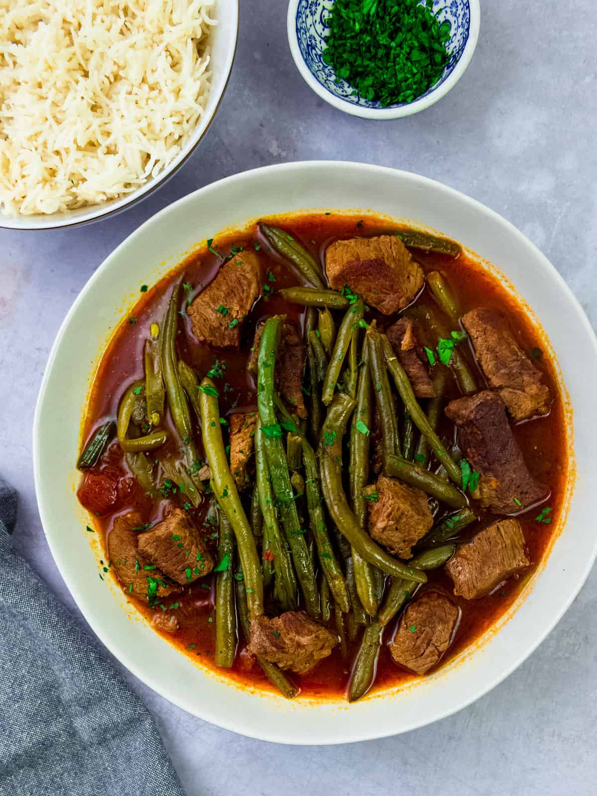 Serve fasulye, a Turkish meat and green bean stew with a side of rice to soak up the delicious tomato broth.