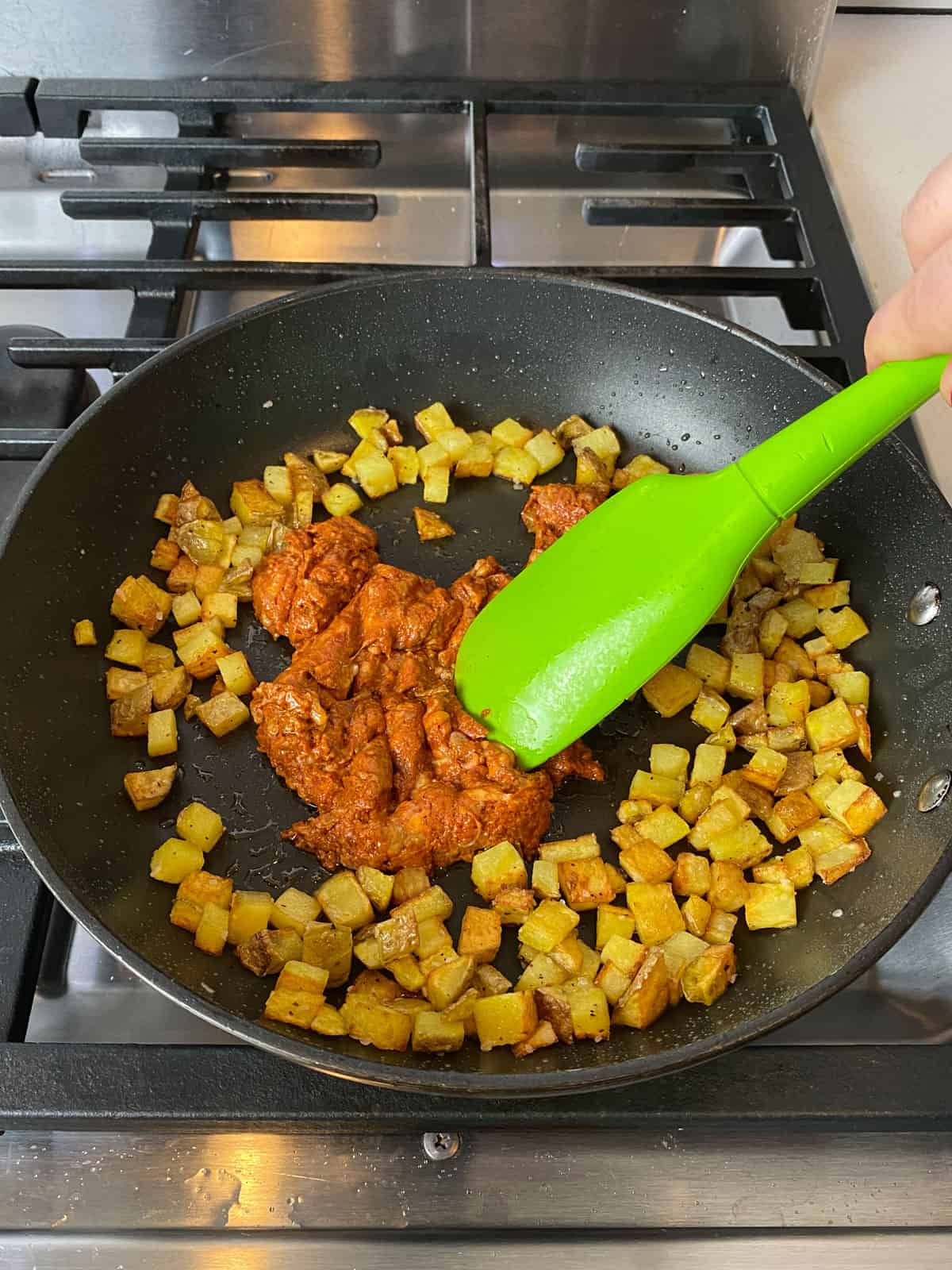 Once the potatoes are cooked, add the chorizo in the center of the skillet and cook until cooked through.