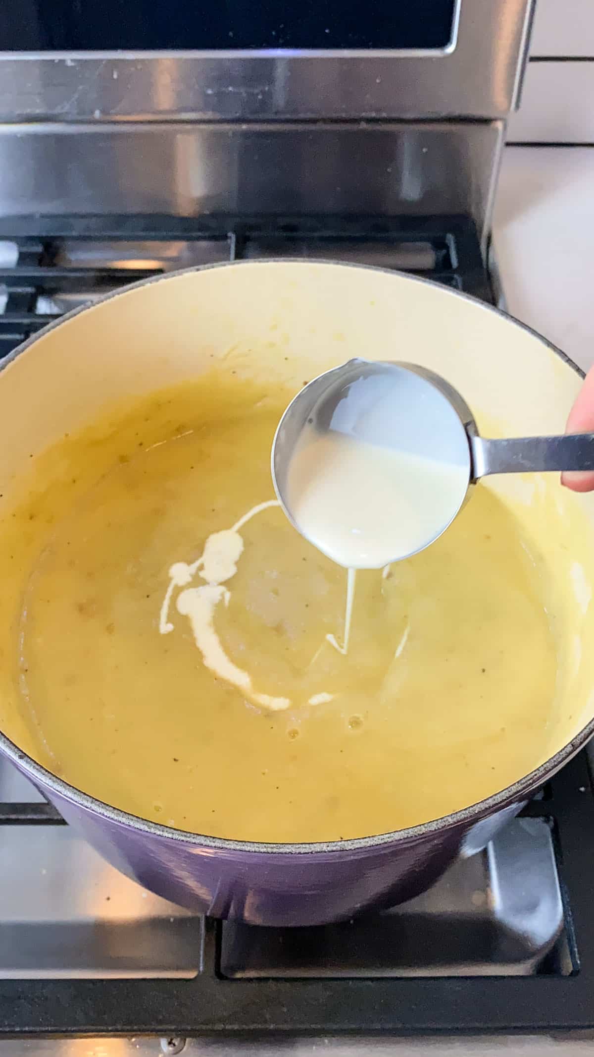 Once the potato leek soup is blended and smooth, stir in heavy cream.