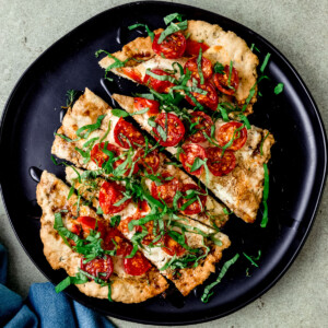 Cheese and tomato flatbread with balsamic glaze.