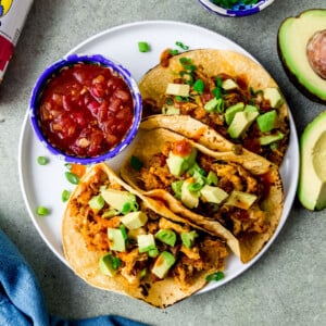 Chorizo breakfast tacos with eggs and potatoes and served with salsa on the side.