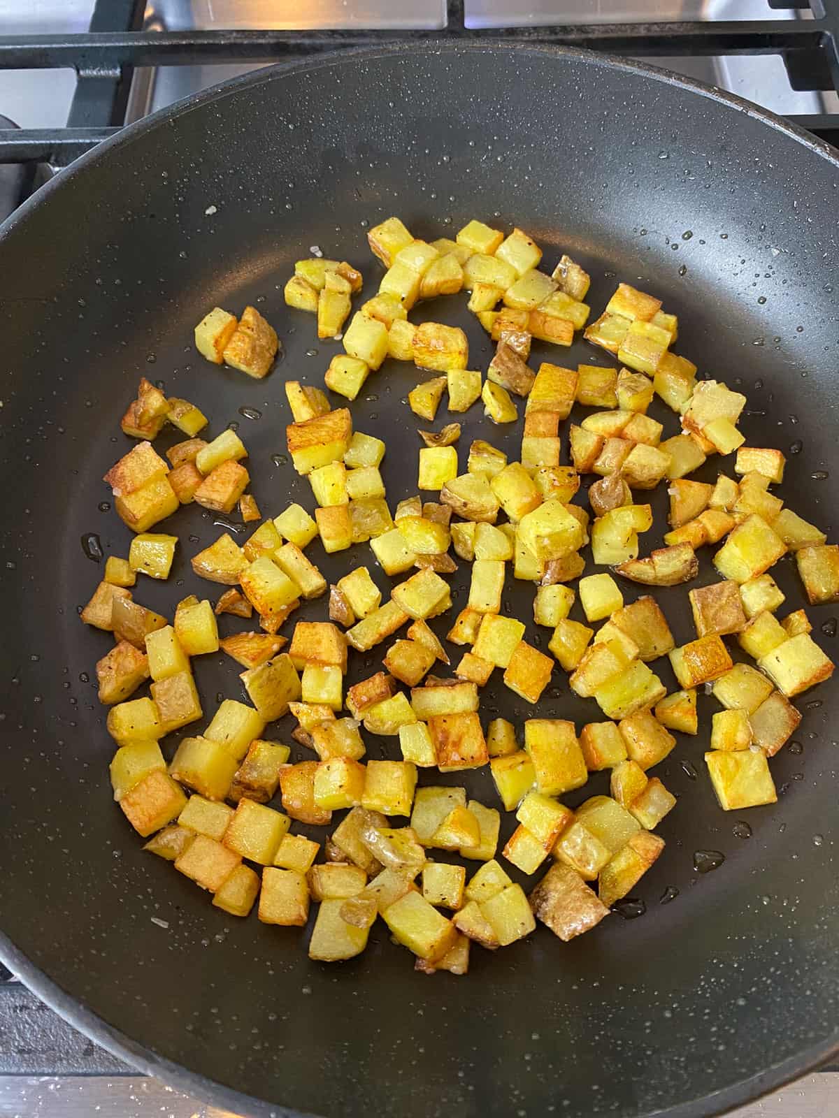 Cook the cubed potatoes until the edges are crispy and golden brown.
