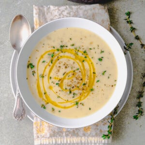 Julia Child's creamy potato leek soup with fresh thyme and olive oil on top.