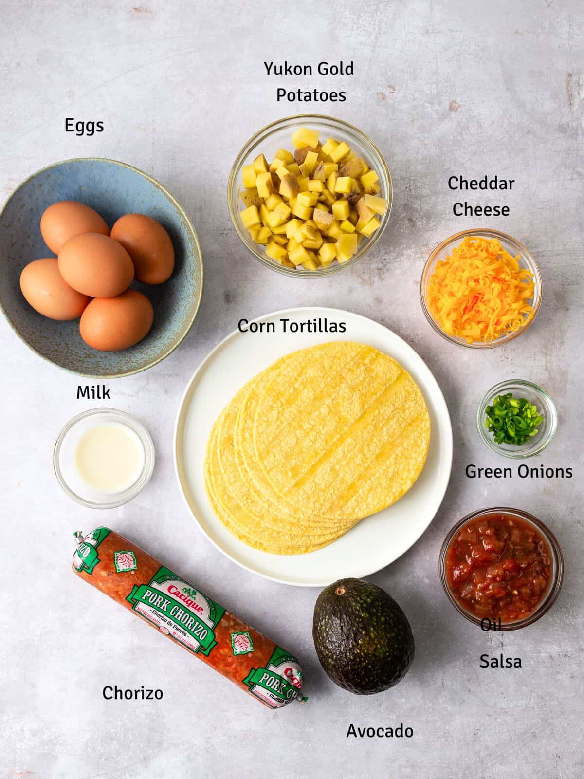 Ingredients for breakfast tacos including chorizo, potatoes and eggs.