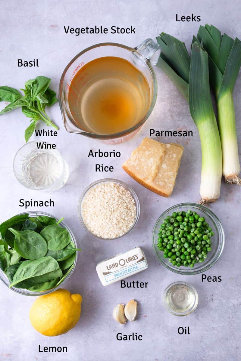 Ingredients for spinach risotto with lemon, peas and leeks.