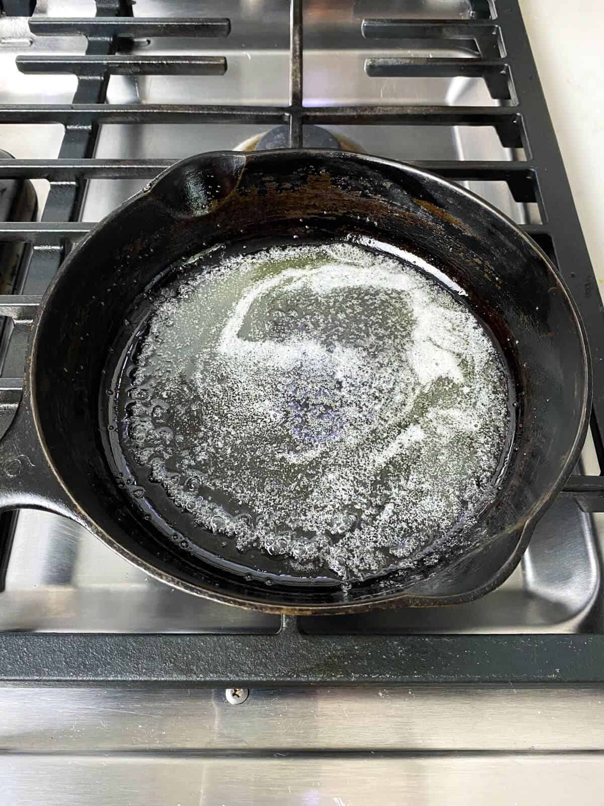 Melt butter into pre-heated cast iron.