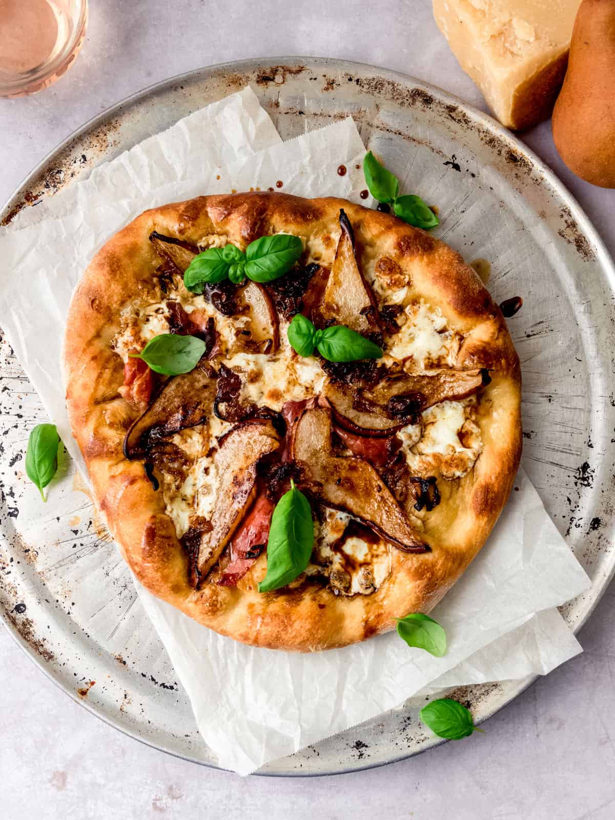Pear and prosciutto pizza with mozzarella, aged balsamic, caramelized shallots and fresh basil.