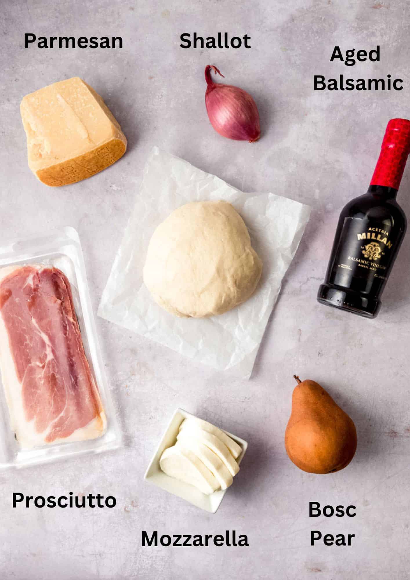 Ingredients for pear and prosciutto pizza, including parmesan cheese.