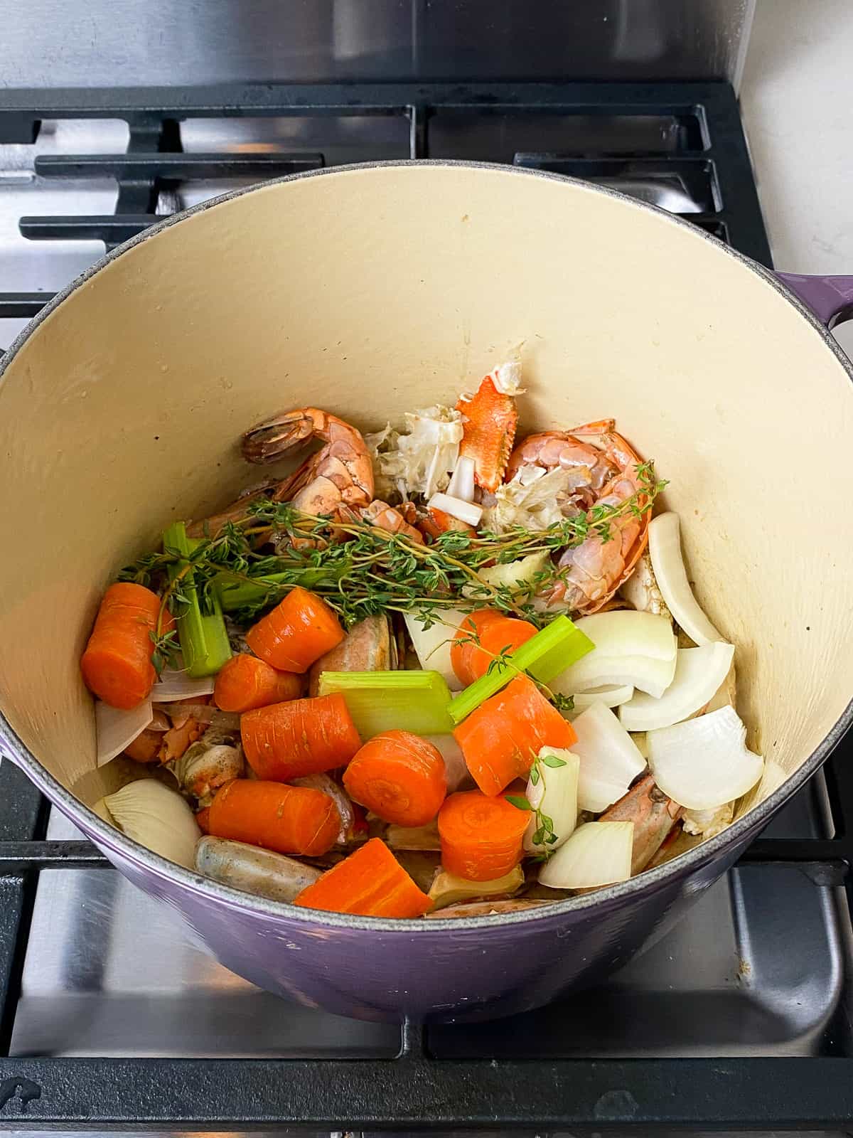 Add the aromatics, including the herbs, carrots, onion and celery.