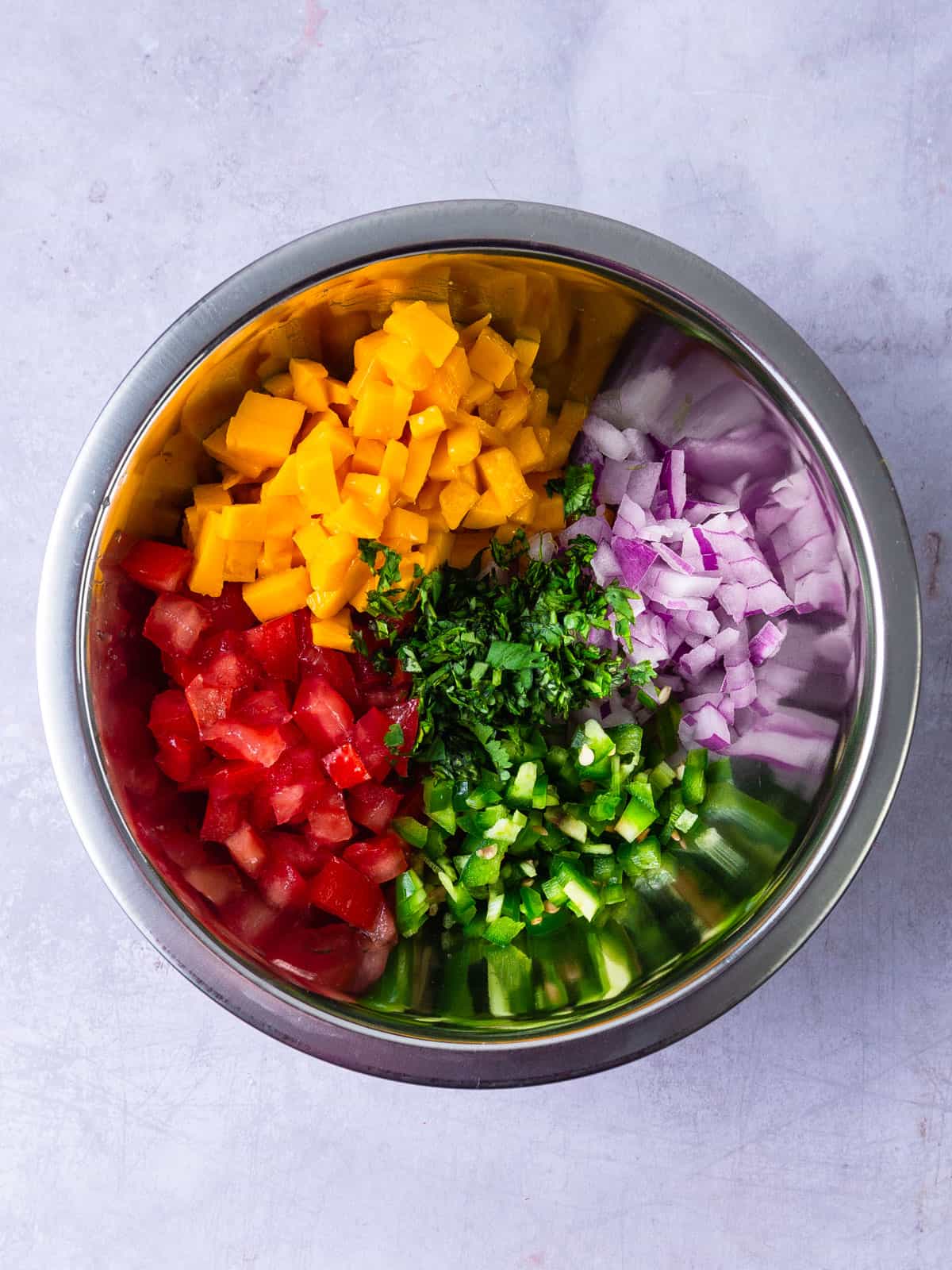 Add all of the mango pico de gallo ingredients to a bowl.