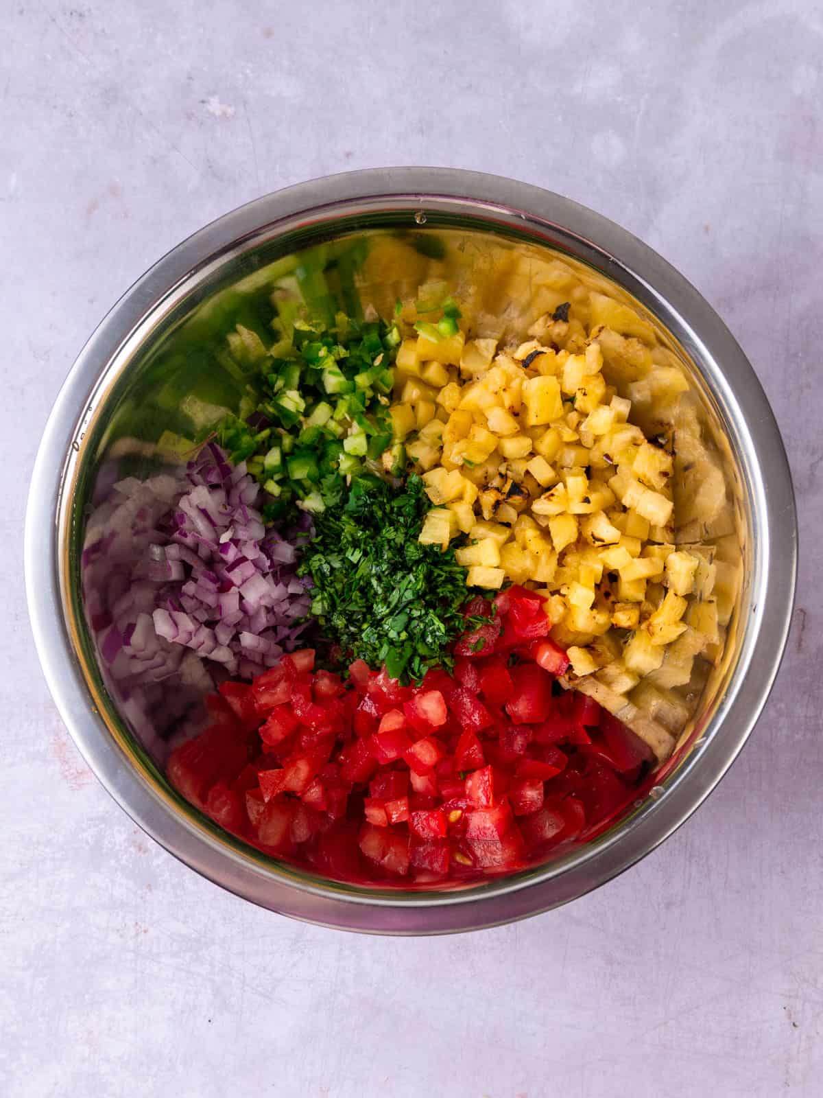 Add all of the pineapple pico de gallo ingredients to a bowl.
