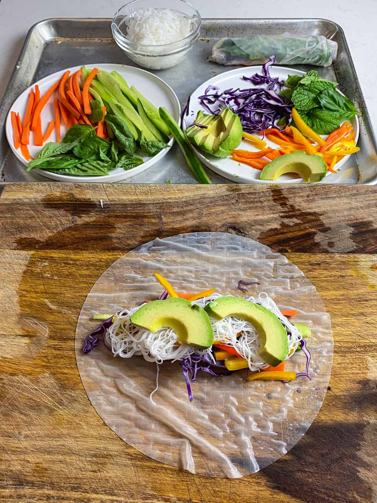 Layer the rice noodles and slices of avocado to the spring rolls.