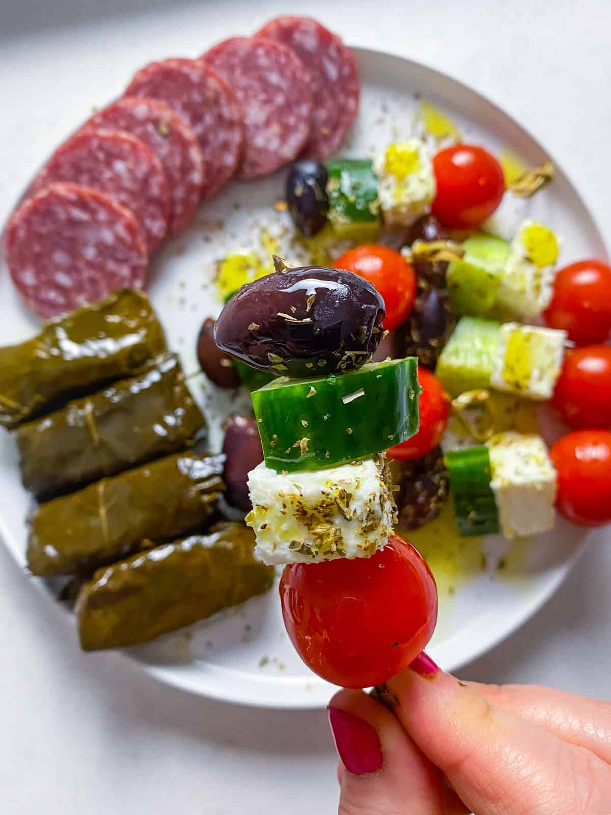 Make Greek salad skewers with feta, cherry tomato, olive and cucumber.