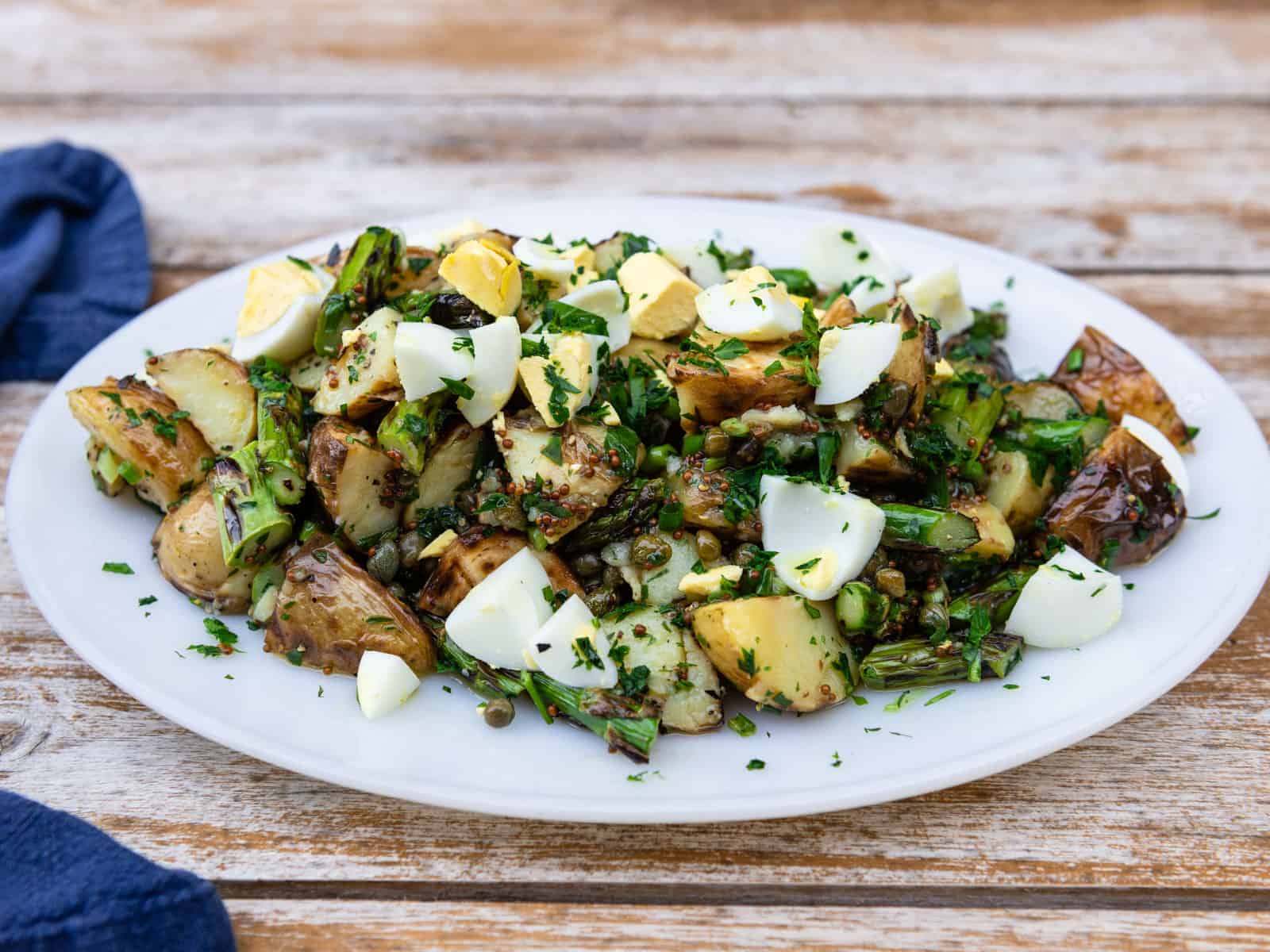 Grilled potato and asparagus salad with capers and hard boiled eggs.