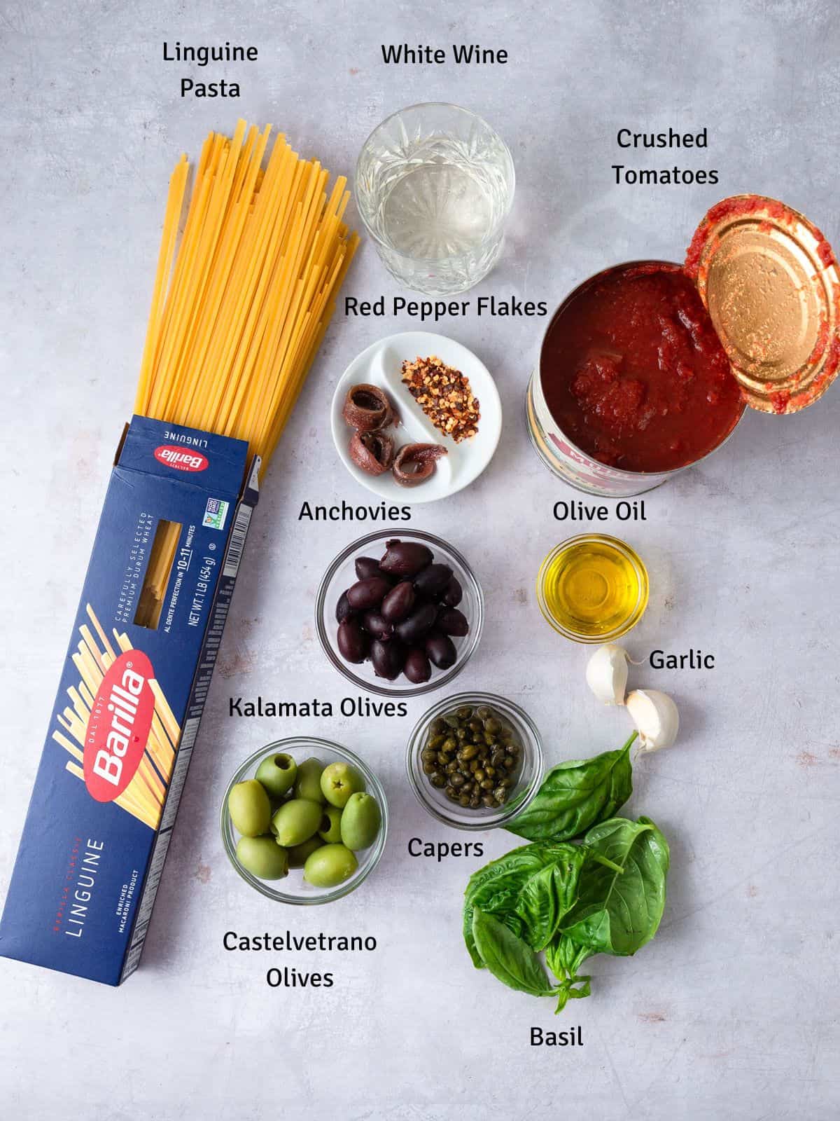 Ingredients for puttanesca pasta, including capers, olives and anchovies.