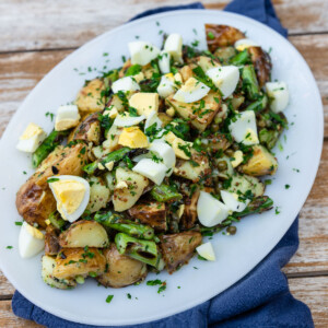 No mayo potato salad with grilled asparagus, capers and dressed in a bright vinaigrette.