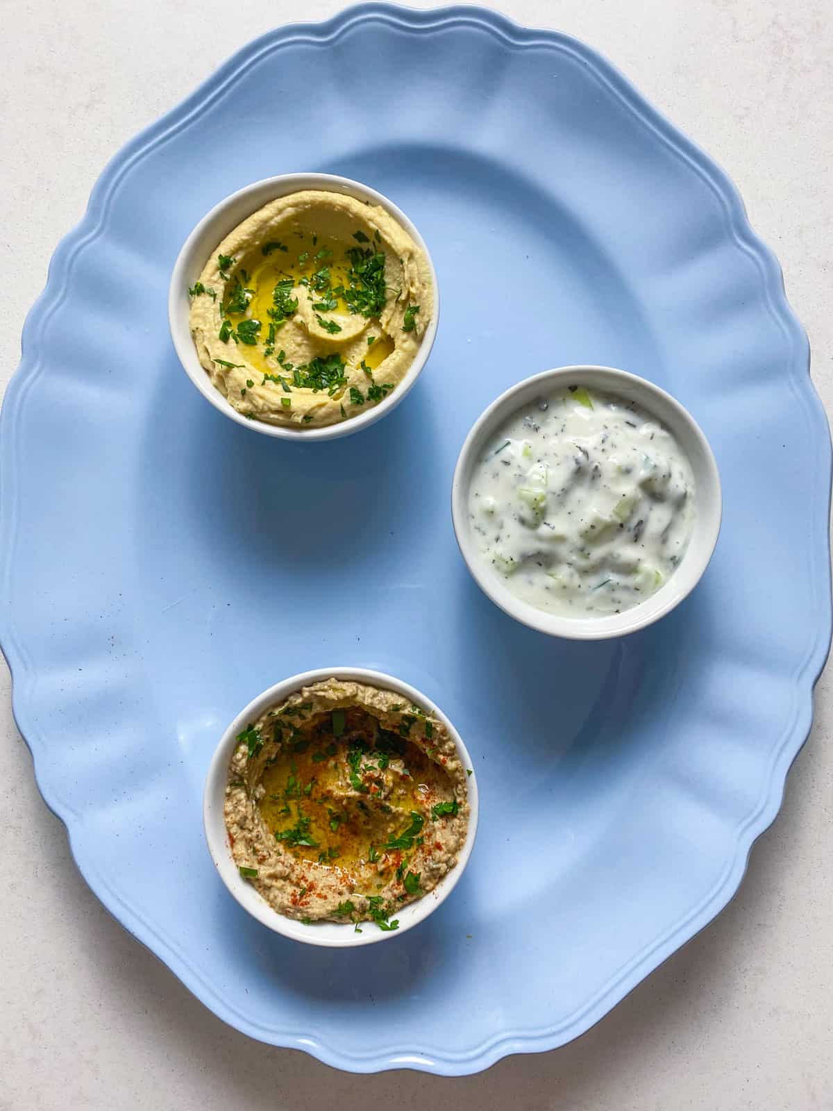 Place bowls on a wide platter before adding more to the Mediterranean mezze board.