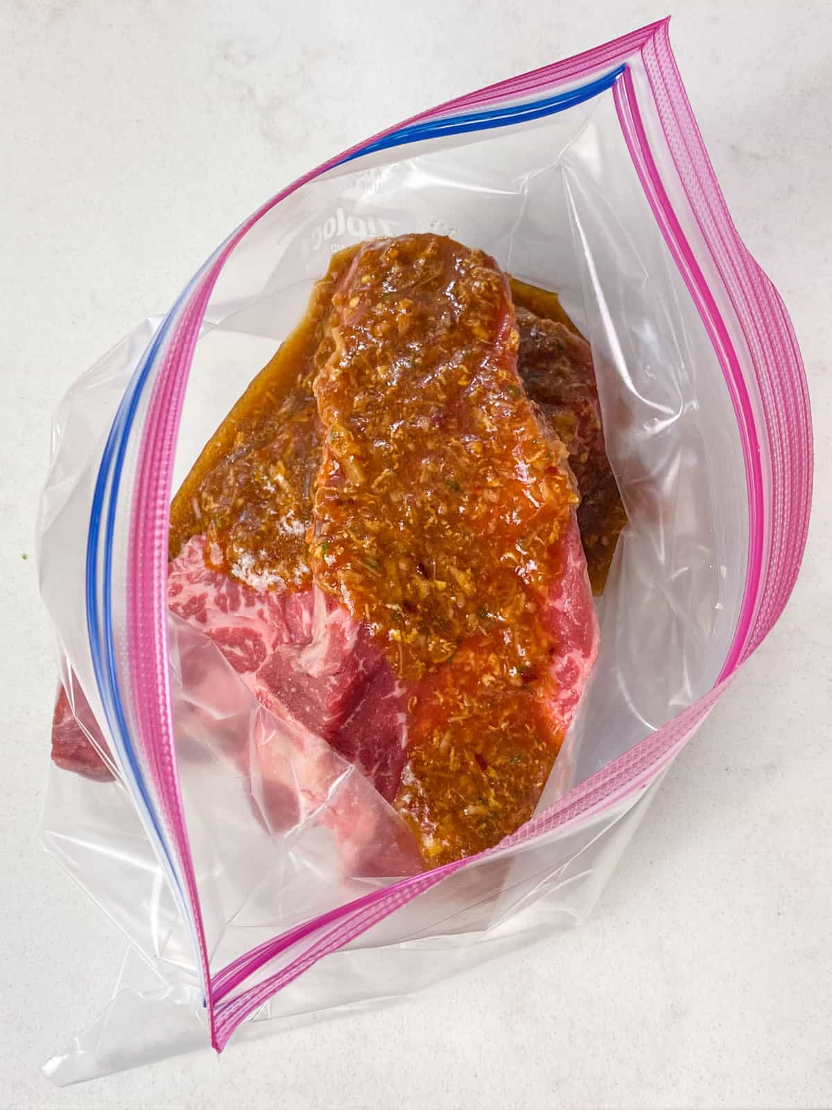 Pour the sweet chili marinade over the steak in a resealable plastic bag.